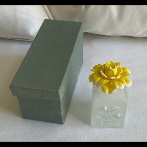 Fragrance bottle with yellow flower